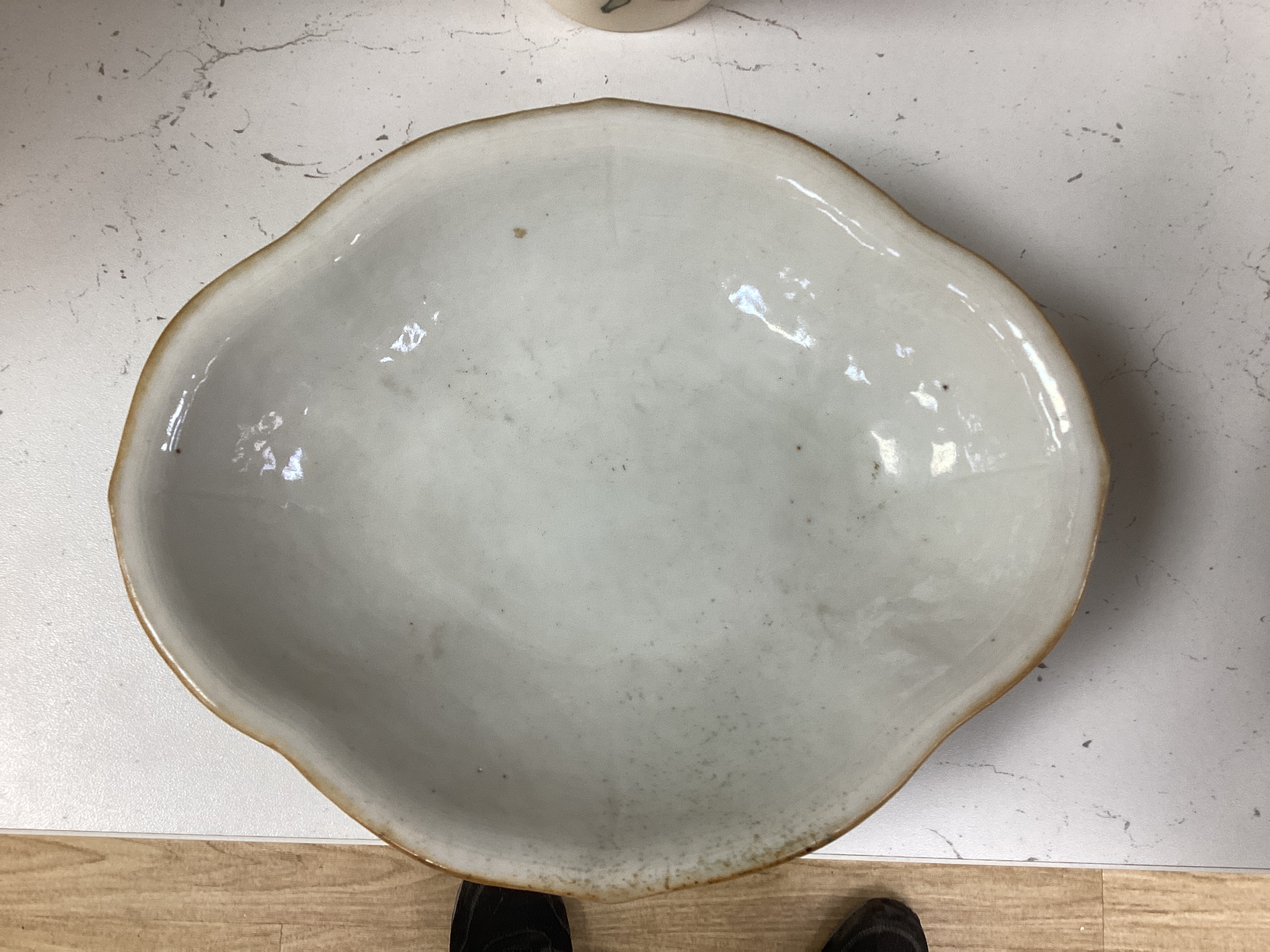 A 19th century Chinese blue and white ingot shaped dish and a famille rose footed dish, the largest 25cm wide (2)